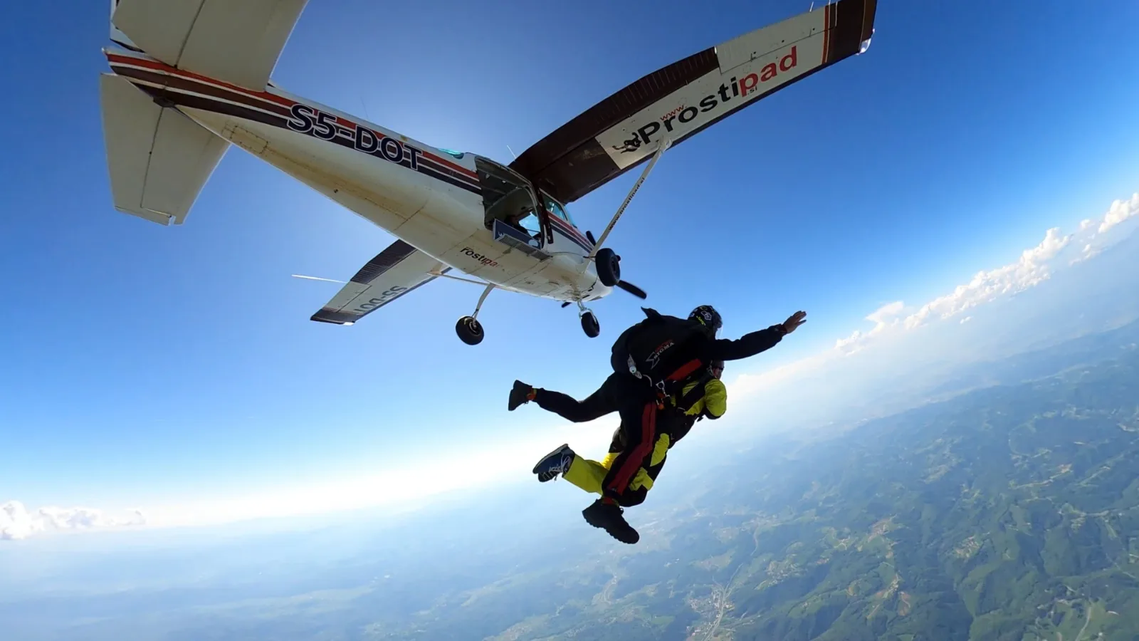 Skydive Academy tandem instructor Marko Premužić jumping out of an airplane in Šentvid