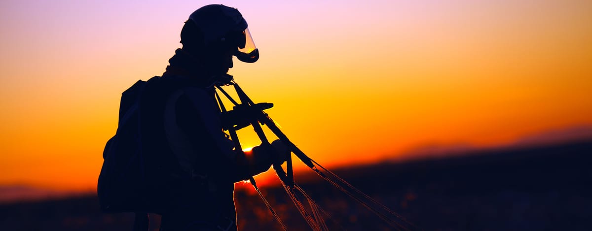 Student skydiver at sunset after landing on learn to skydive course.