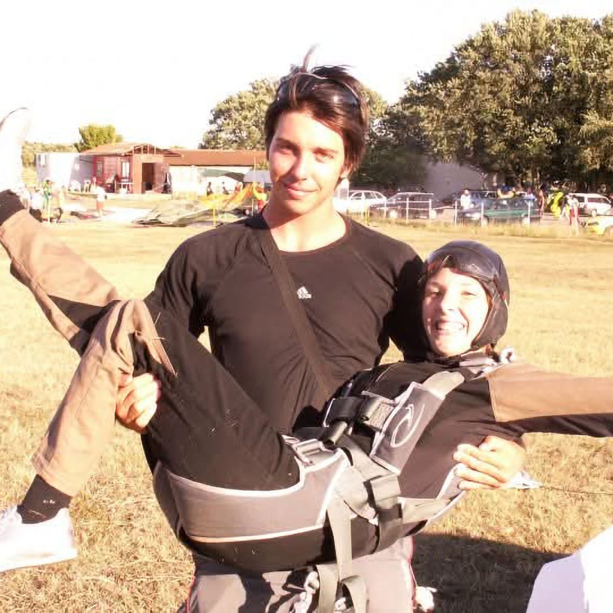 Bianca Ignjatov after her first tandem skydive in Vrsar, smiling as young Marko Premužić holds her at the landing area.