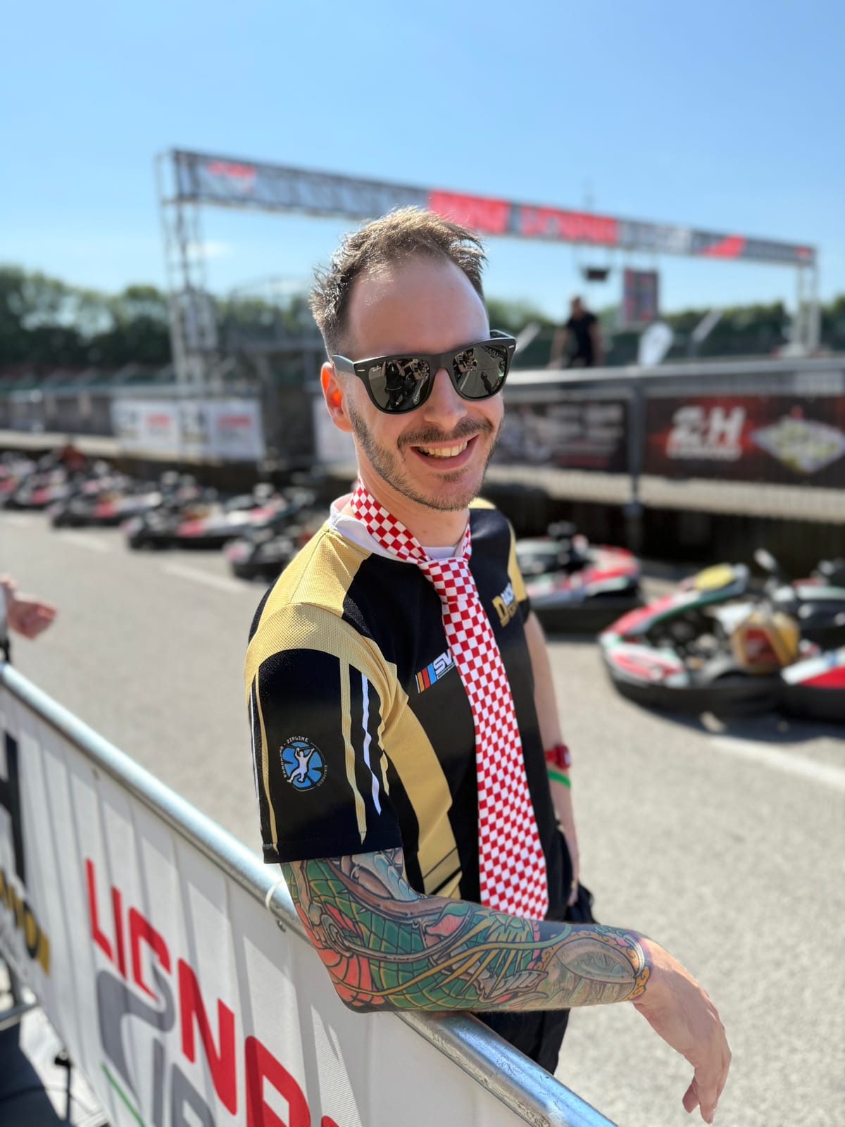 Petar Klešković, Skydive Academy vice-president and USPA Coach, smiling trackside at Lignano 24 endurance karting race in Italy.